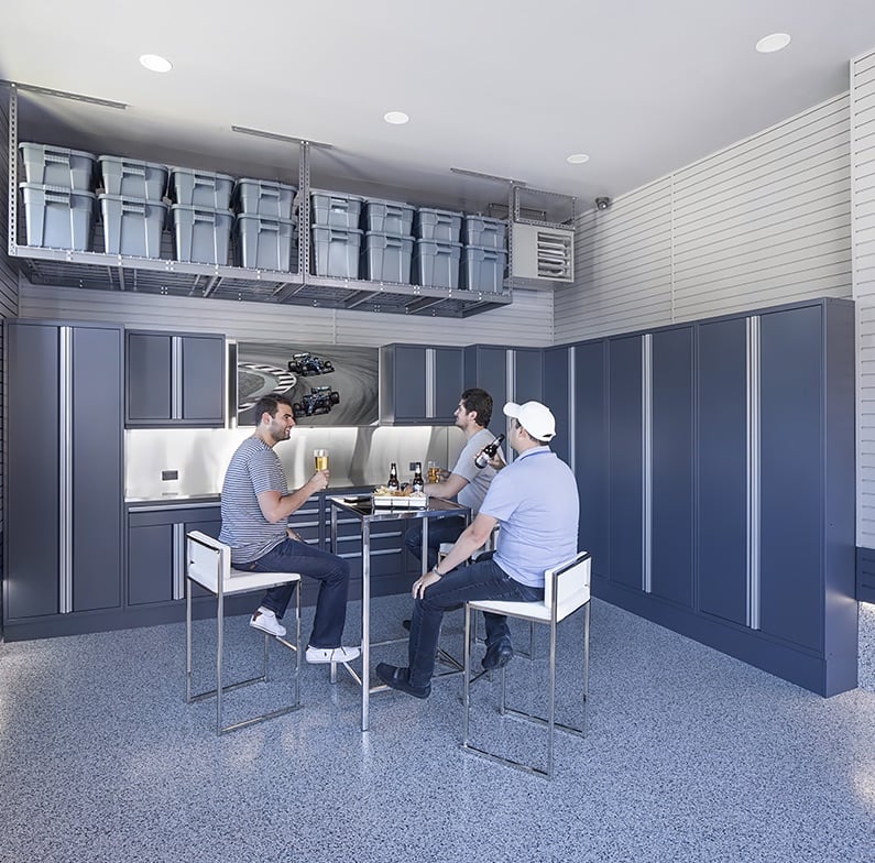 three men relaxing in garage