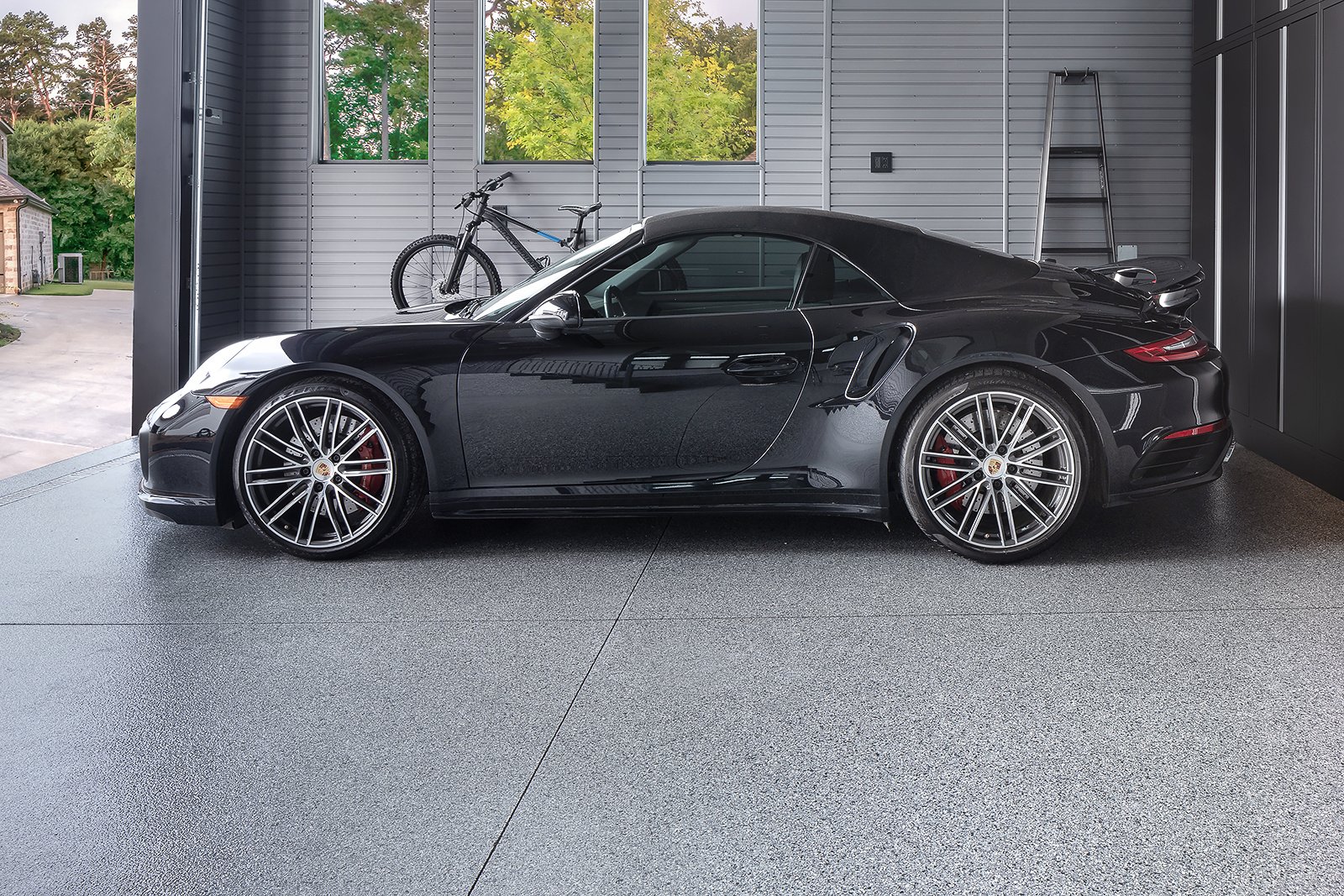 polyaspartic floor coating in garage with black Porsche