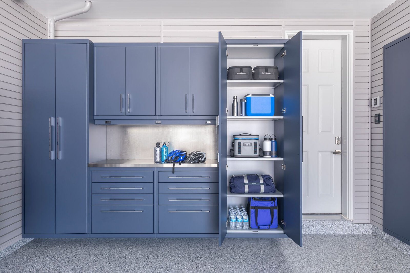 Storage cabinets protect your belongings from dust and keeps them more securely stored with locks. Custom cabinets like this GL Custom Steel model give garages a professional, high-end look.