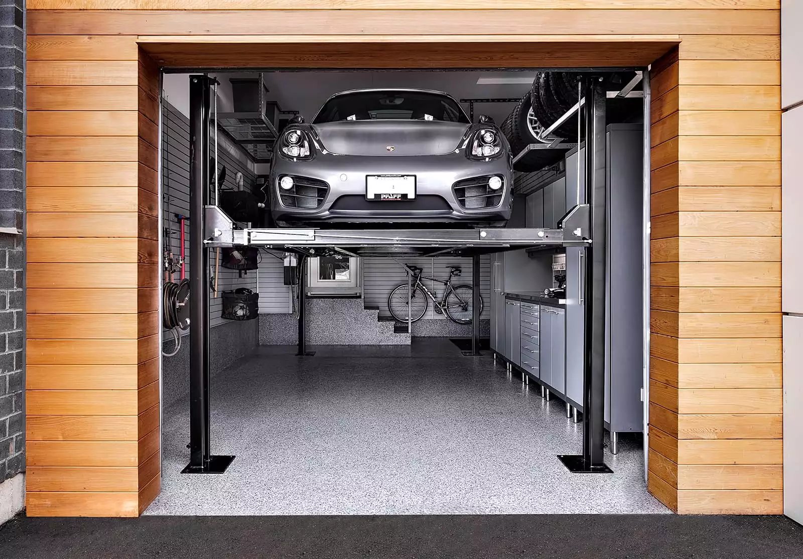 Silver Porsche Car Lift up by Garage Living