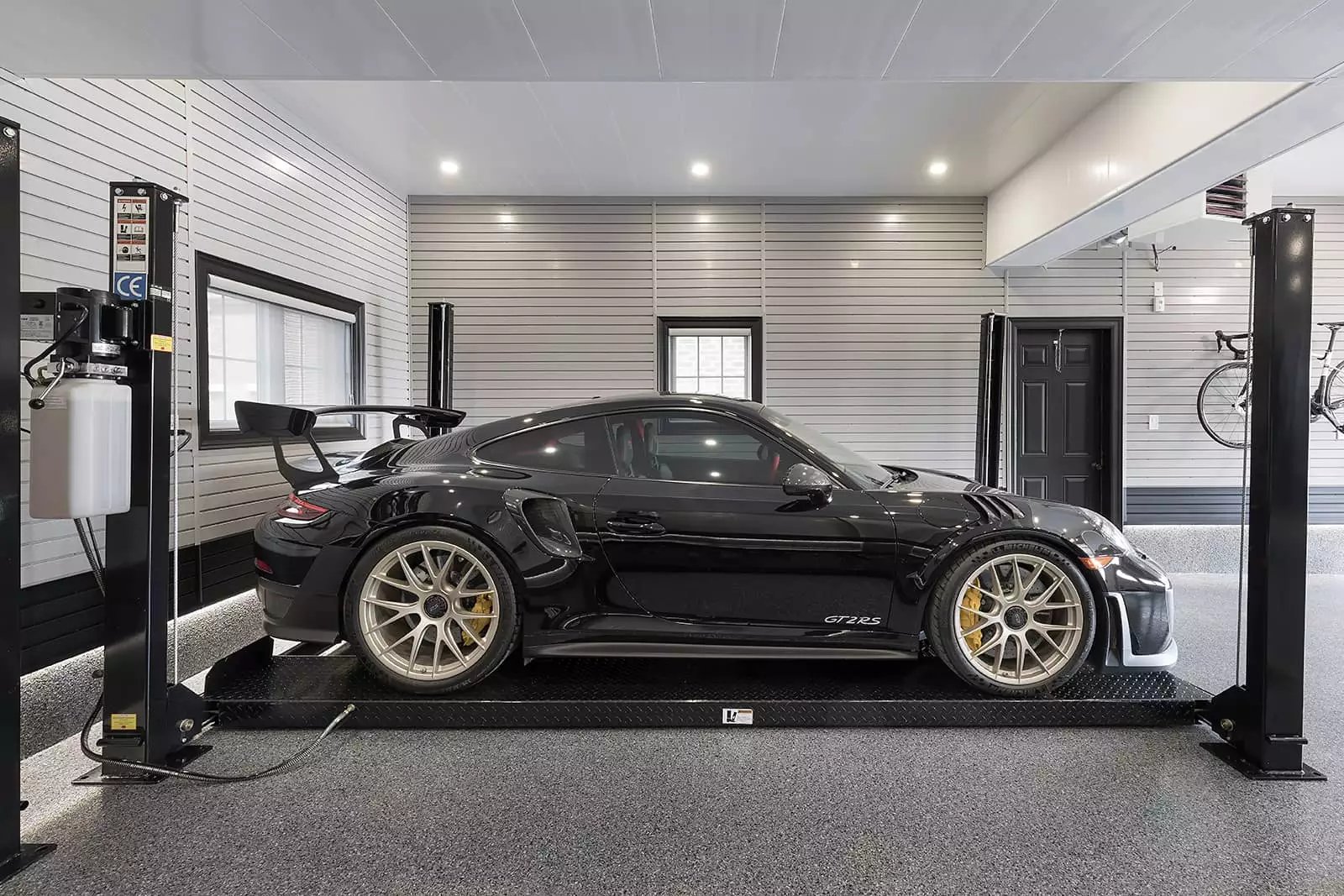 Black Porsche  in a car lift by Garage Living 