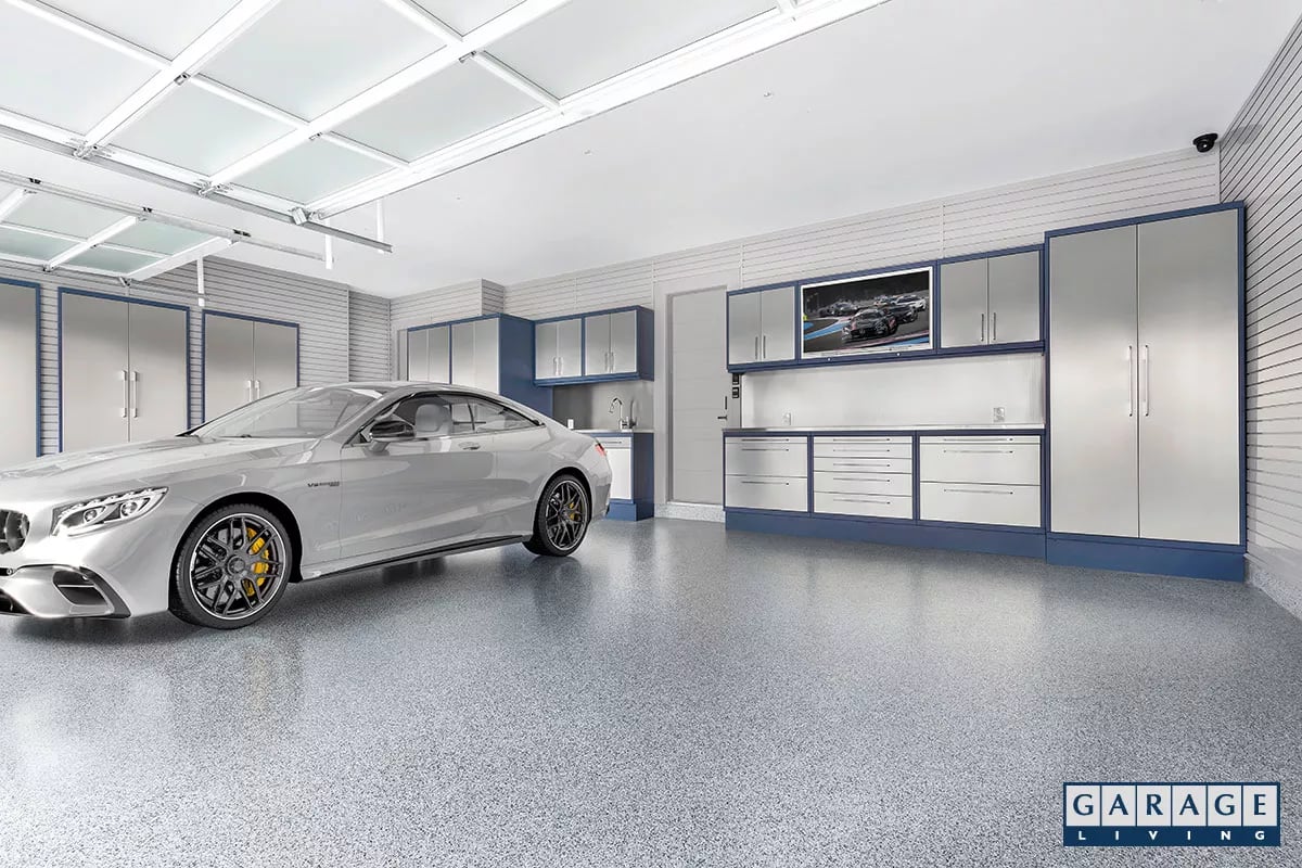 Luxury car in a garage with Custom Steel cabinetry system&nbsp;with stainless steel doors and drawers - Garage Living